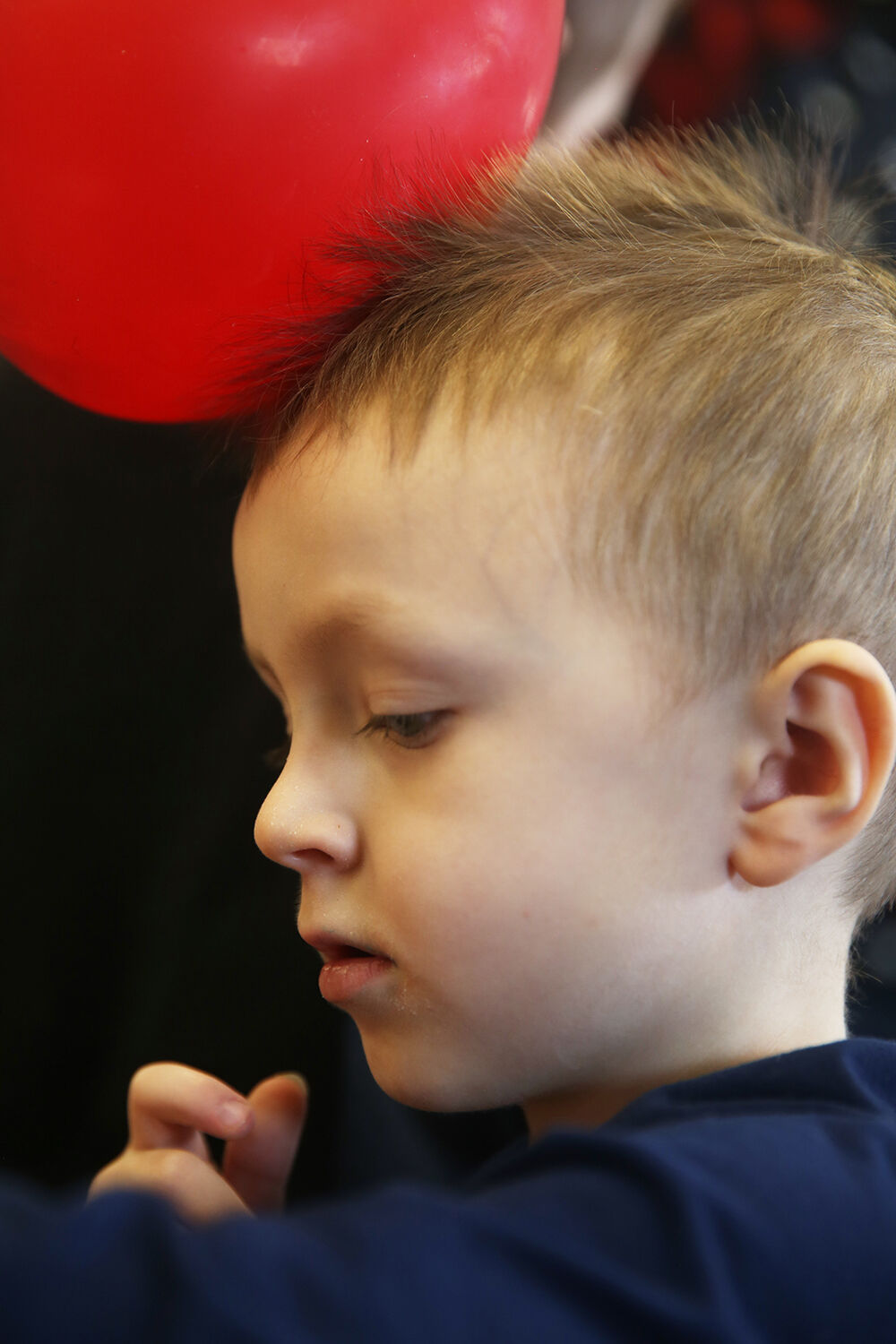 Greyson Thom, 4, adds stickers to his hat